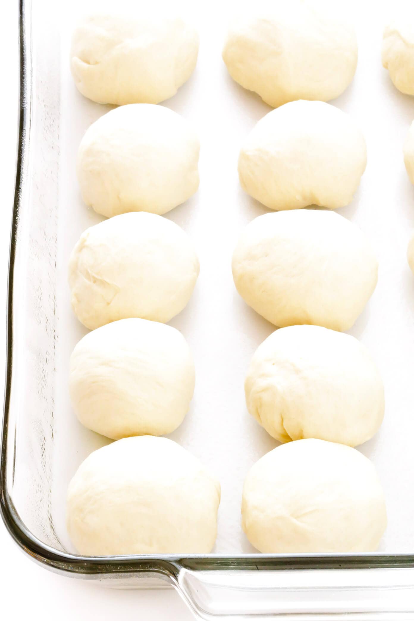 My favorite 1-Hour Soft and Buttery Dinner Rolls recipe is easy to make by hand or with a stand mixer, perfectly soft and fluffy, and so buttery and delicious! Options to make them with garlic, herbs, or extra-cheesy included too! | gimmesomeoven.com #dinner #rolls #buns #side #thanksgiving #christmas #bread #holidays #bake Dinner Rolls Bread Dough Before Baking