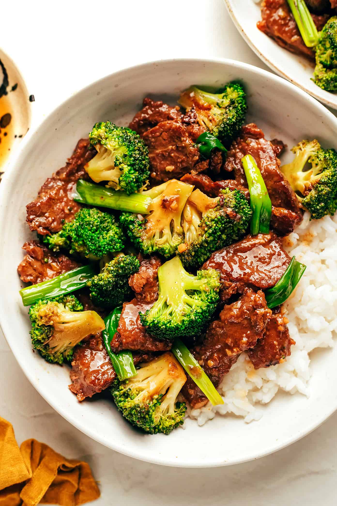 This easy beef and broccoli stir-fry features tender steak, crisp broccoli, and a bold, garlicky sauce — all ready in just 30 minutes. beef and broccoli served over rice in bowl