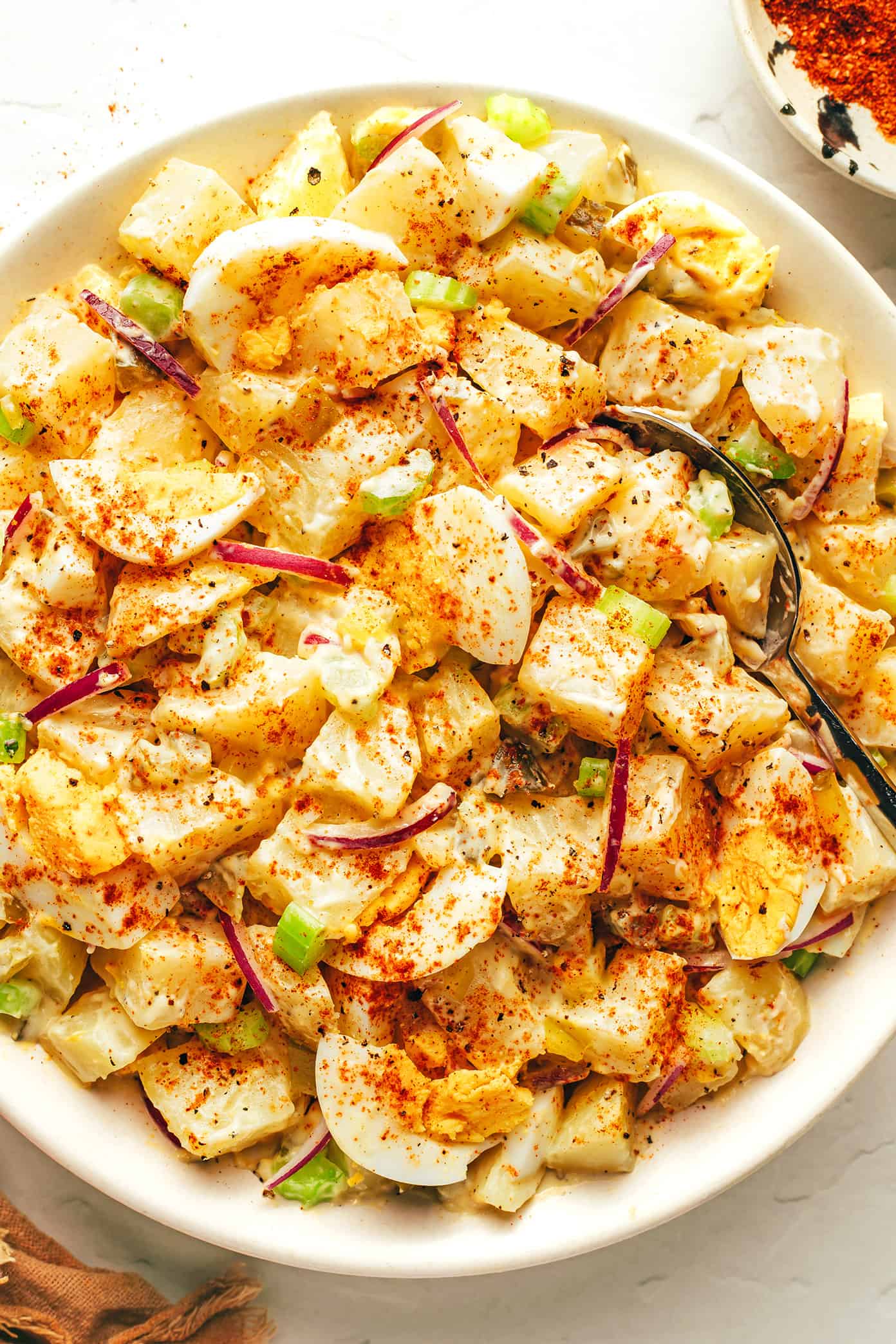 My go-to classic potato salad recipe is easy to make with tender potatoes, hard-boiled eggs, crisp veggies, pickle relish, and a zesty creamy dressing. It's the perfect make ahead side dish for potlucks, picnics and barbecues. And feel free to add some extra bacon or cheese if you'd like! | gimmesomeoven.com The BEST Potato Salad Recipe