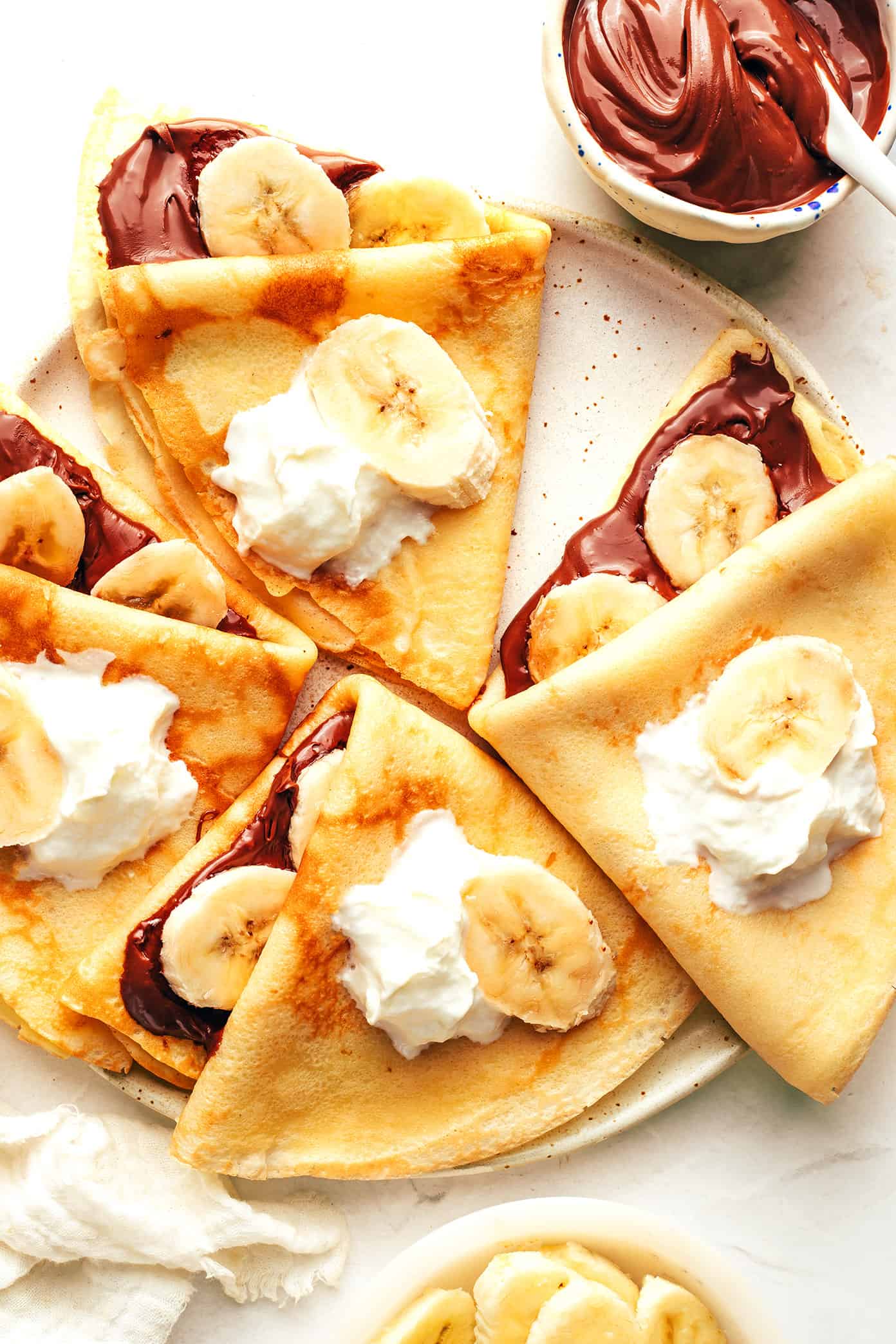 This classic French crepe recipe is easy to make in the blender with 7 basic ingredients. Always such a lovely, simple recipe for breakfast or brunch. Feel free to customize with your favorite sweet or savory fillings! | gimmesomeoven.com Crepes with bananas and Nutella