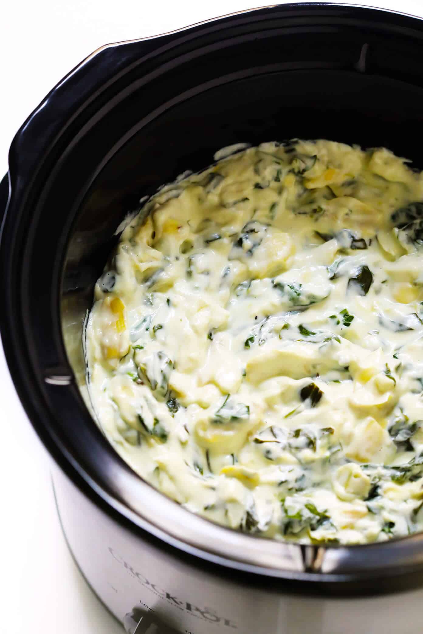 This Slow Cooker Spinach Artichoke Dip recipe is rich and creamy, full of great flavor, and extra-easy to make in the crockpot! The perfect easy appetizer or game day snack. | gimmesomeoven.com #dip #appetizer #spinach #artichoke #vegetarian #glutenfree #entertaining #holiday #gameday Slow Cooker Spinach Artichoke Dip Recipe