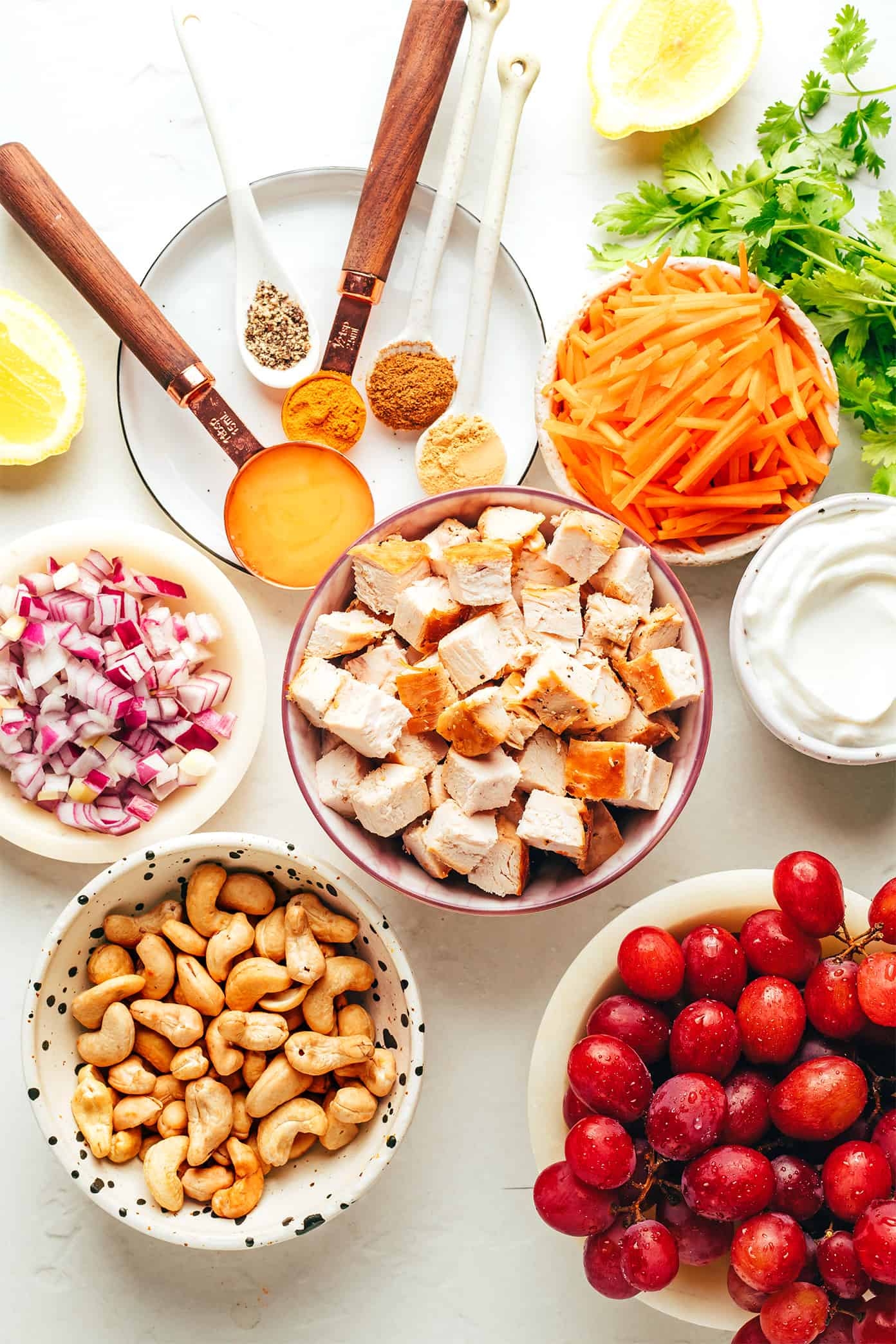 This copycat Trader Joe's curry chicken salad recipe is made with diced chicken, grapes, carrots, cashews, red onions, and a creamy Greek yogurt curry sauce. Serve in sandwiches, lettuce wraps, with crackers for dipping, or whatever sounds good! It's a high protein recipe that's perfect for meal prep and always hits the spot. | gimmesomeoven.com Curry chicken salad ingredients