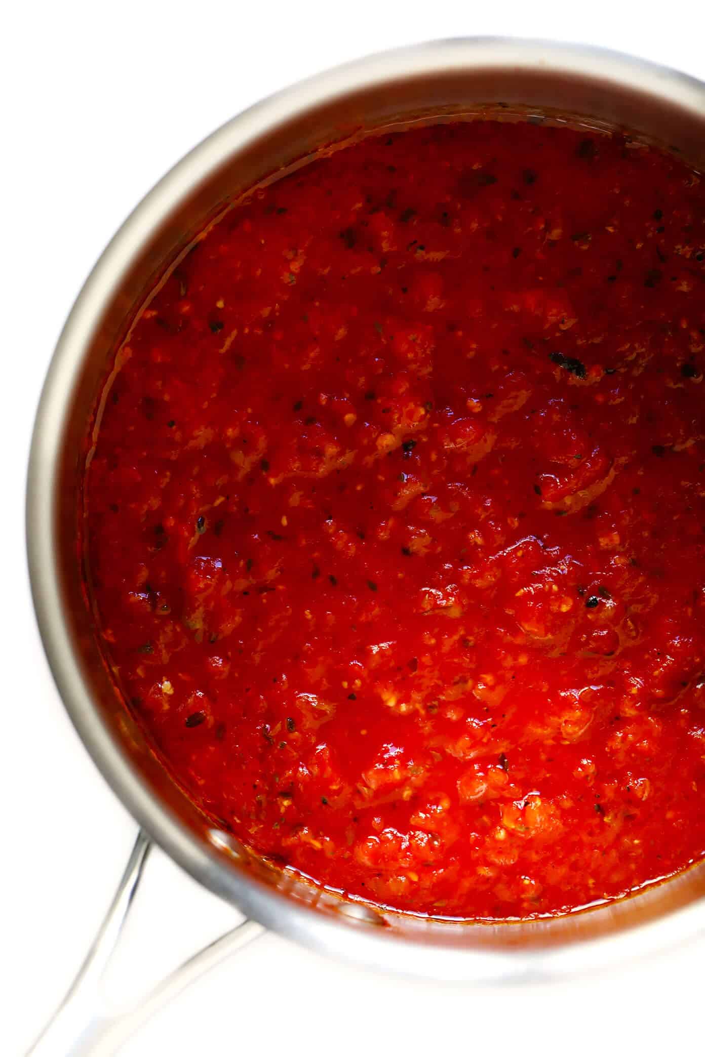 This homemade marinara sauce recipe is easy to make, naturally gluten-free and vegan, and slow-simmered with the BEST tomato, basil and garlicky flavors. Serve it with spaghetti, meatballs, pizza, chicken, mussels, eggplant Parmesan, subs, or whatever sounds good! | gimmesomeoven.com #marinara #sauce #tomato #pasta #glutenfree #vegetarian #vegan #healthy #mealprep #freezermeal #dinner Homemade Marinara Sauce