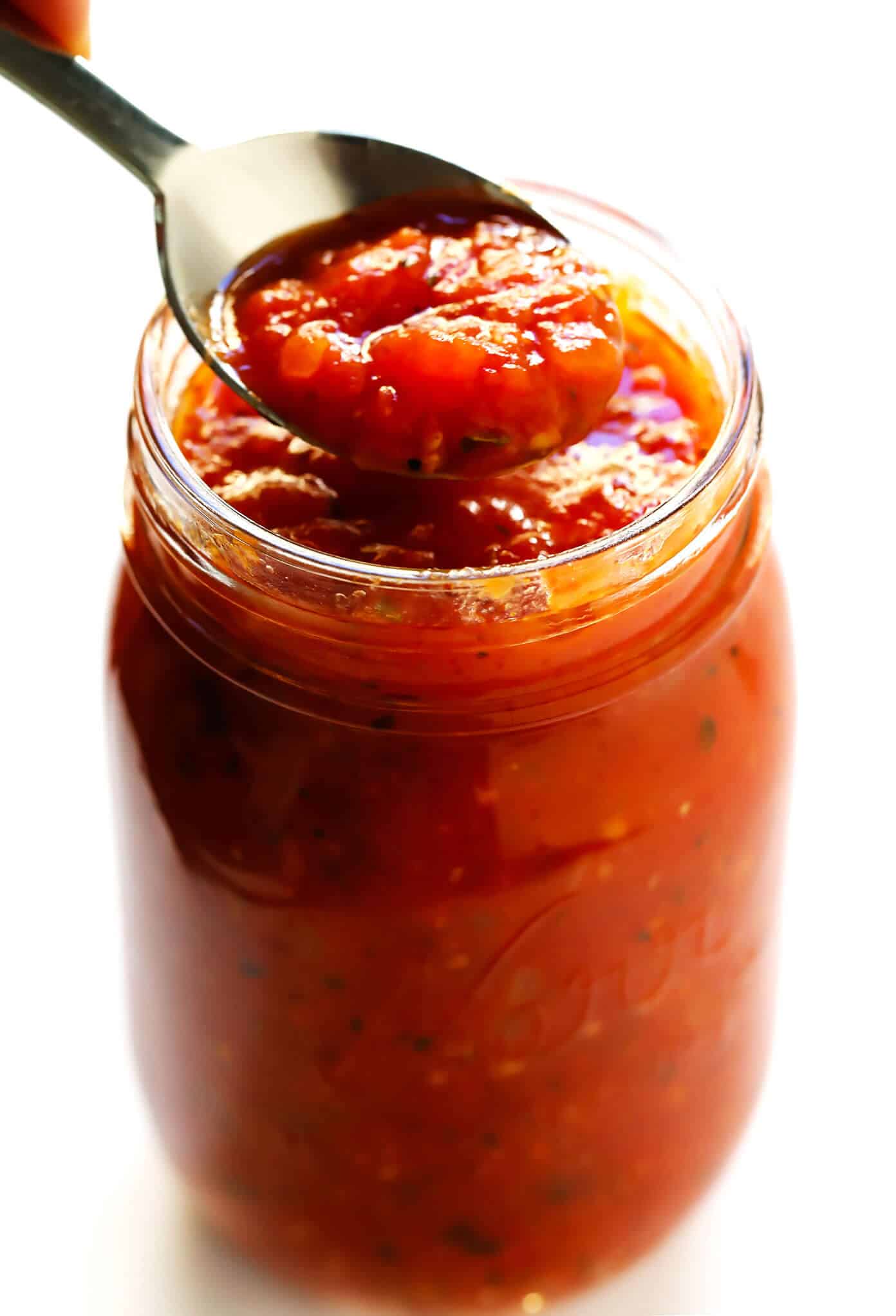 This homemade marinara sauce recipe is easy to make, naturally gluten-free and vegan, and slow-simmered with the BEST tomato, basil and garlicky flavors. Serve it with spaghetti, meatballs, pizza, chicken, mussels, eggplant Parmesan, subs, or whatever sounds good! | gimmesomeoven.com #marinara #sauce #tomato #pasta #glutenfree #vegetarian #vegan #healthy #mealprep #freezermeal #dinner Marinara Sauce