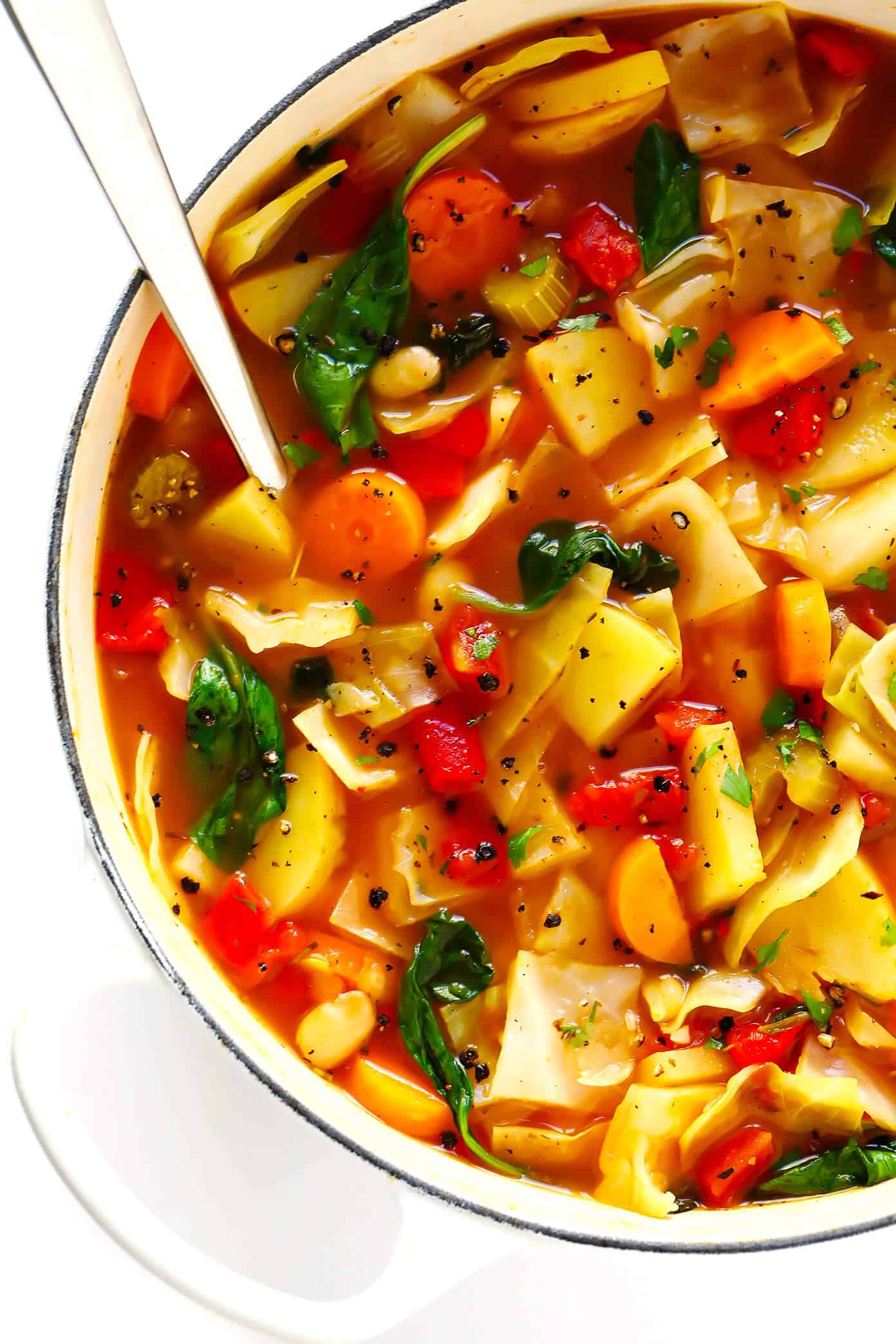 This Spicy Vegetarian Cabbage Soup recipe is made from a mountain of vegetables, simmered in a spicy broth, and tastes like total comfort food. It's also naturally gluten-free and vegan. It's easy to make on the stovetop, or in the Instant Pot (pressure cooker) or Crockpot (slow cooker). It's easy to make ahead for meal prep, or freeze as a freezer meal. And it's SO DELICIOUS. | Gimme Some Oven #cabbage #soup #healthy #dinner #vegan #vegetarian #vegetable #recipe #instantpot #crockpot Healthy Spicy Cabbage Soup Recipe | Vegetarian, Vegan and Gluten-Free