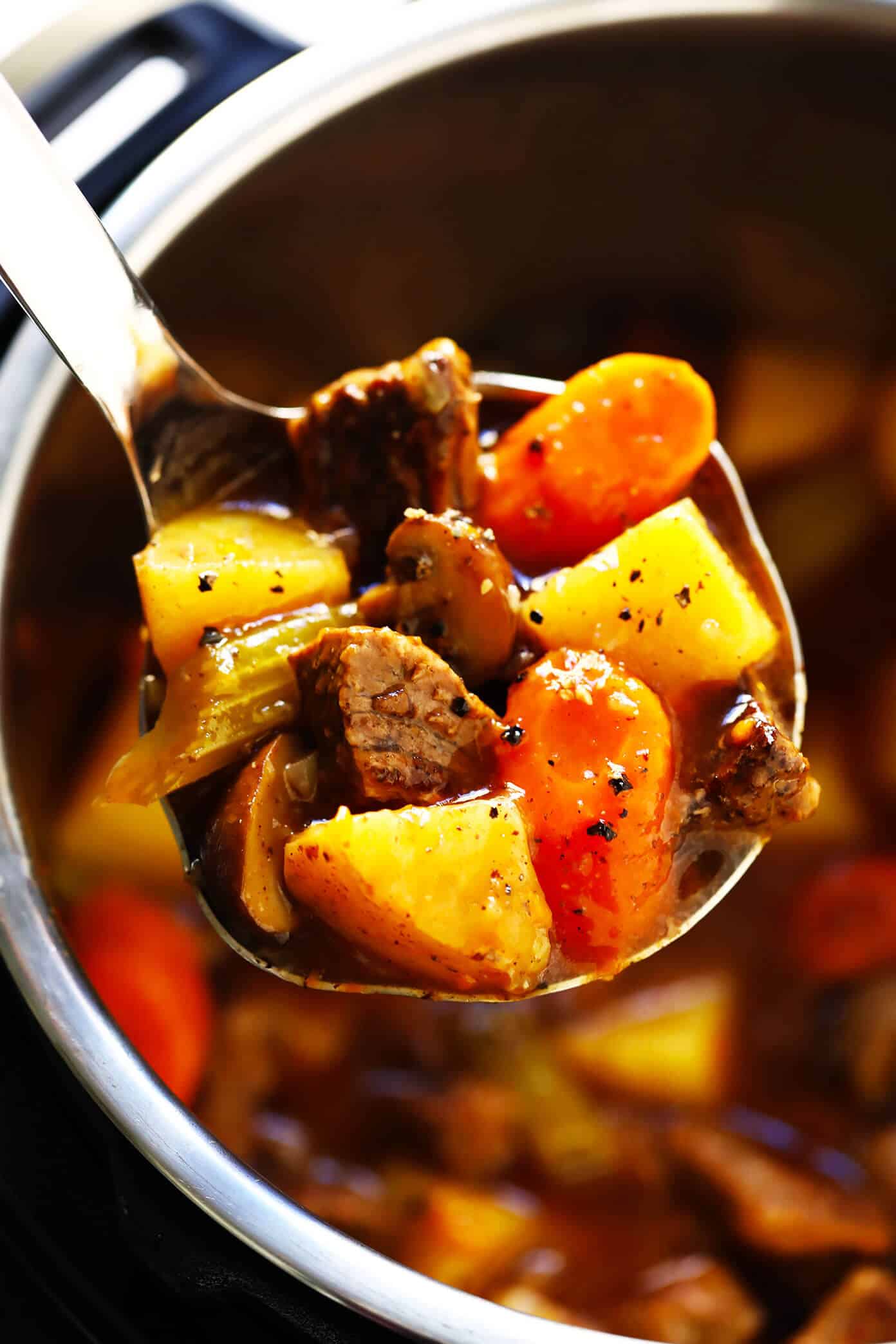 My favorite classic Beef Stew recipe -- full of tender steak, hearty potatoes, carrots, celery, onions, mushrooms and a savory tomato herb gravy. It's easy to make in the Instant Pot (pressure cooker) or Crock Pot (slow cooker), and always SO hearty and delicious. | gimmesomeoven.com #beef #stew #steak #soup #instantpot #crockpot #dinner #mealprep #glutenfree Beef Stew (Crock Pot or Instant Pot)