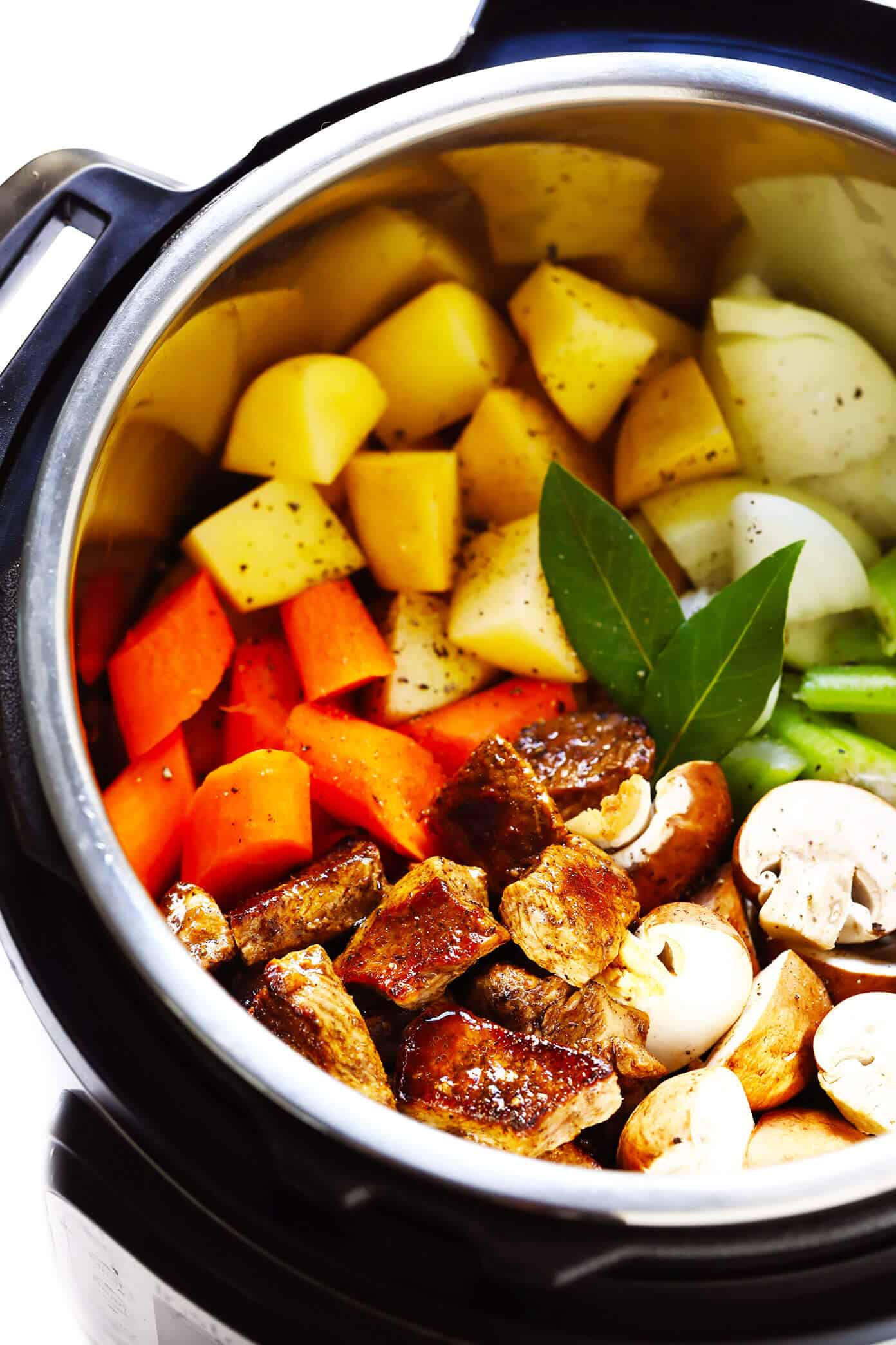 My favorite classic Beef Stew recipe -- full of tender steak, hearty potatoes, carrots, celery, onions, mushrooms and a savory tomato herb gravy. It's easy to make in the Instant Pot (pressure cooker) or Crock Pot (slow cooker), and always SO hearty and delicious. | gimmesomeoven.com #beef #stew #steak #soup #instantpot #crockpot #dinner #mealprep #glutenfree The Best Beef Stew Ingredients