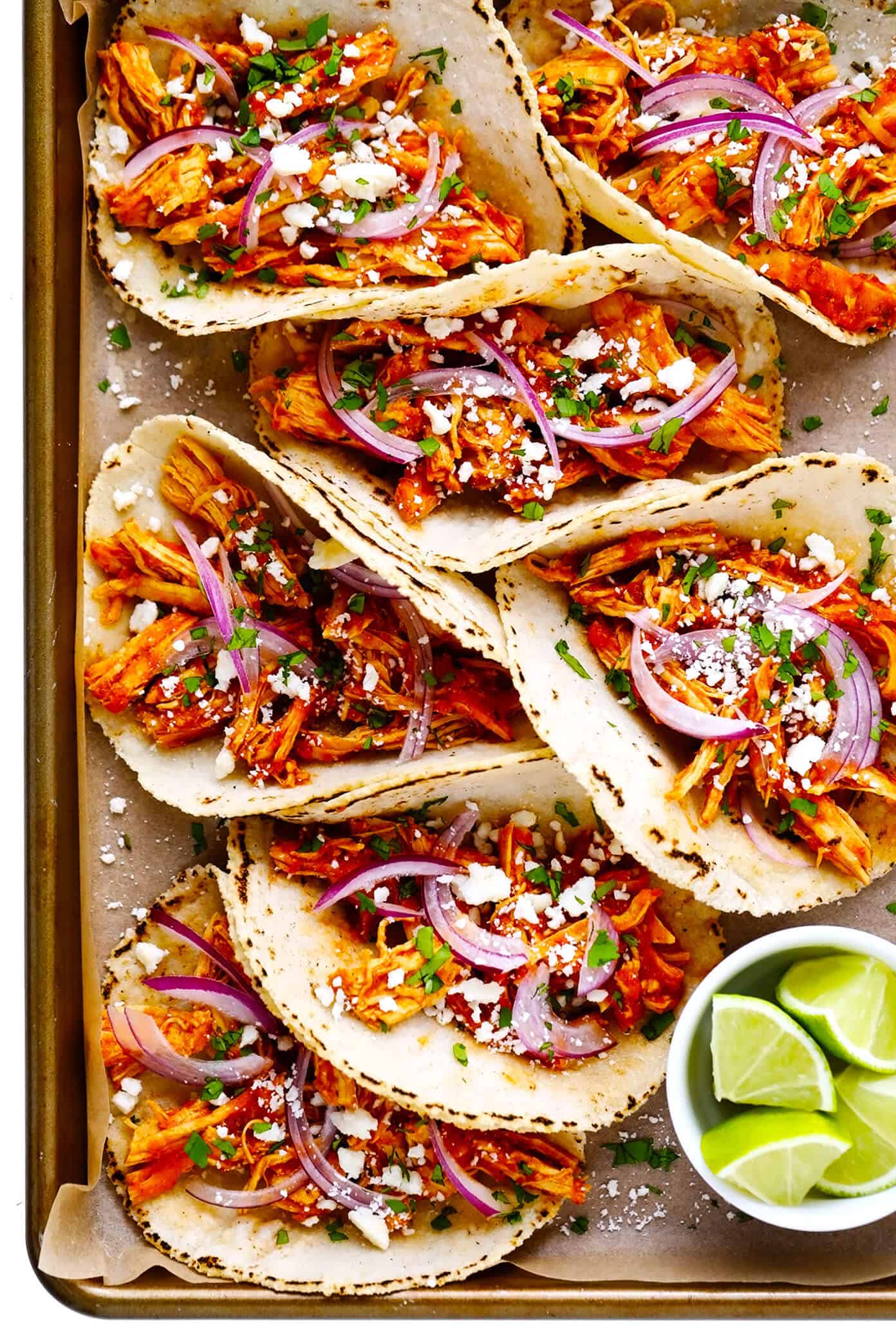 This Mexican Chicken Tinga recipe is remarkably quick and easy to make in 30 minutes and tossed with the best smoky, savory, and slightly-sweet tomato sauce. It's naturally gluten-free and perfect for serving for dinner in tacos, tostadas, burritos, quesadillas and more! | gimmesomeoven.com Chicken Tinga Tacos