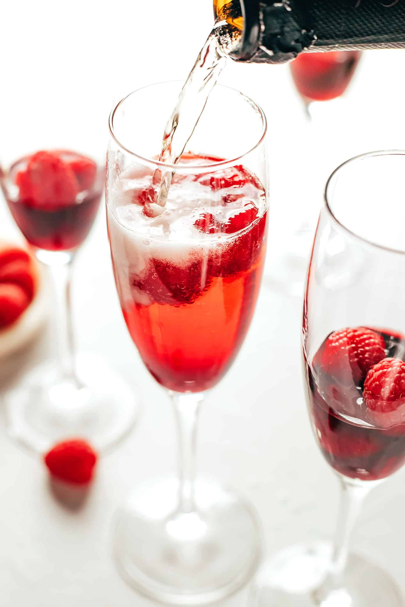 This classic kir royale cocktail recipe is easy to make with dry sparkling wine (such as Champagne, cava or prosecco), crรจme de cassis (blackcurrant liqueur) and your choice of berries for garnish. It's a vibrant, bubbly, refreshing drink that's perfect for summertime! | gimmesomeoven.com Kir Royale