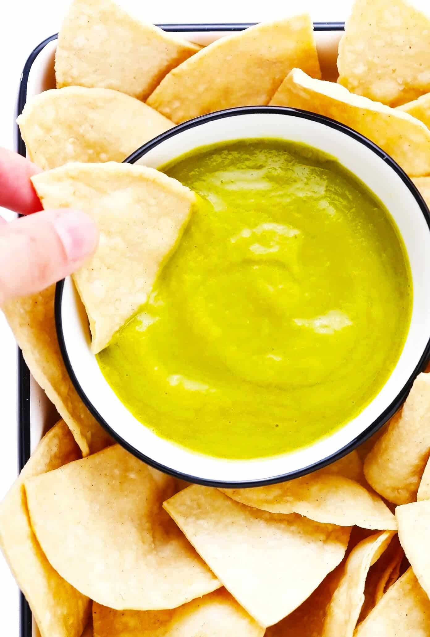 This 5-ingredient creamy jalapeño salsa recipe is easy to make in 30 minutes and irresistibly garlicky and flavorful. Perfect for dipping with chips or drizzling on whatever other Mexican-inspired dishes you love best. It is naturally gluten-free and vegan, and options are included to make this salsa as mild or spicy as you prefer. | gimmesomeoven.com Creamy Jalapeño Salsa with Tortilla Chips