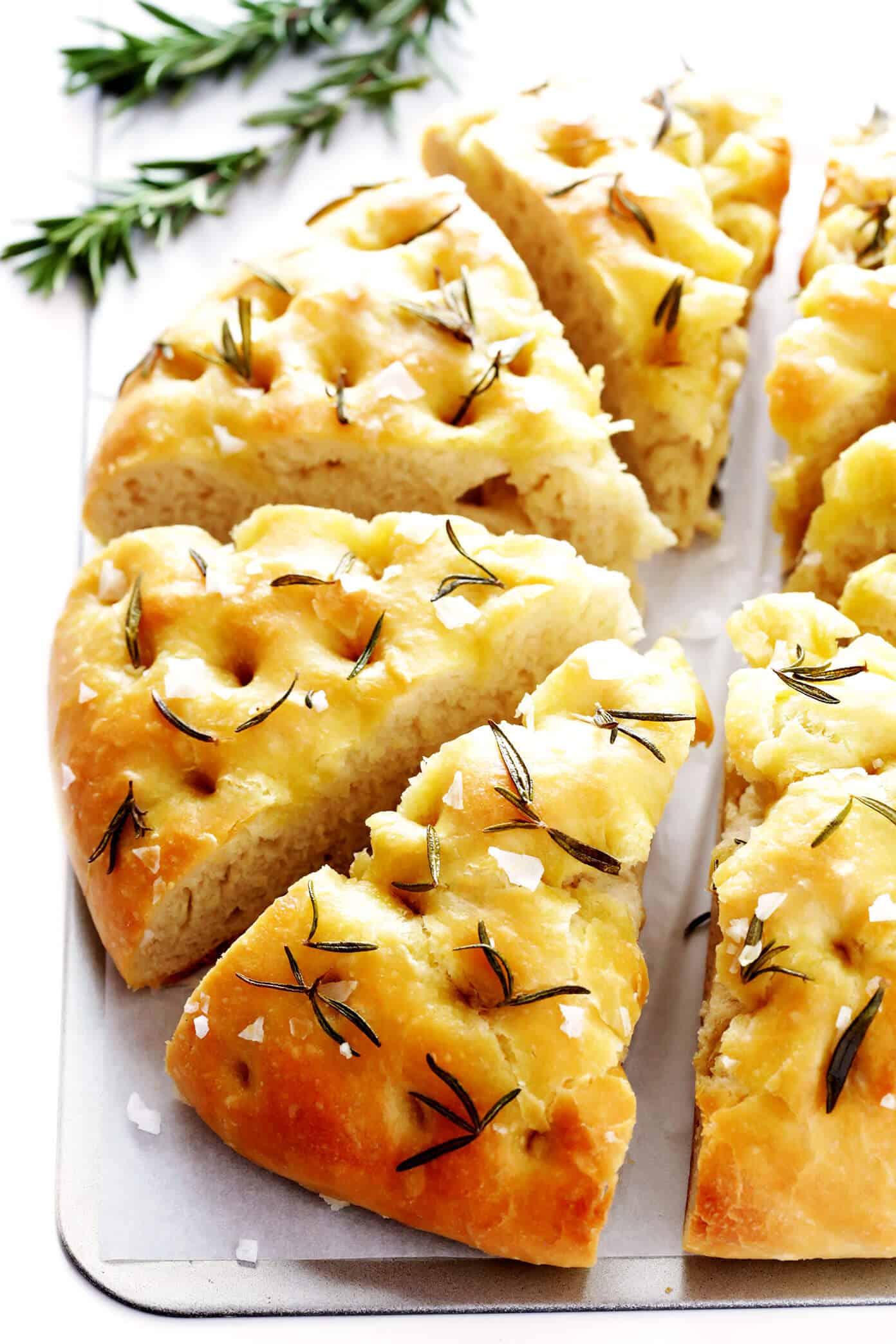 This delicious Rosemary Focaccia Bread recipe is easy to make, and topped with fresh rosemary, olive oil and flaky sea salt. Easy to make as a side for dinner, and it also freezes well! | gimmesomeoven.com #focaccia #bread #italian #side #vegetarian #baking Rosemary Focaccia Bread Recipe