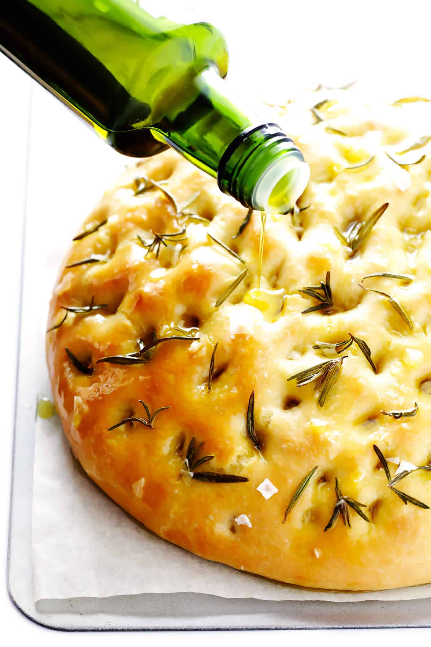 This delicious Rosemary Focaccia Bread recipe is easy to make, and topped with fresh rosemary, olive oil and flaky sea salt. Easy to make as a side for dinner, and it also freezes well! | gimmesomeoven.com #focaccia #bread #italian #side #vegetarian #baking Focaccia Recipe