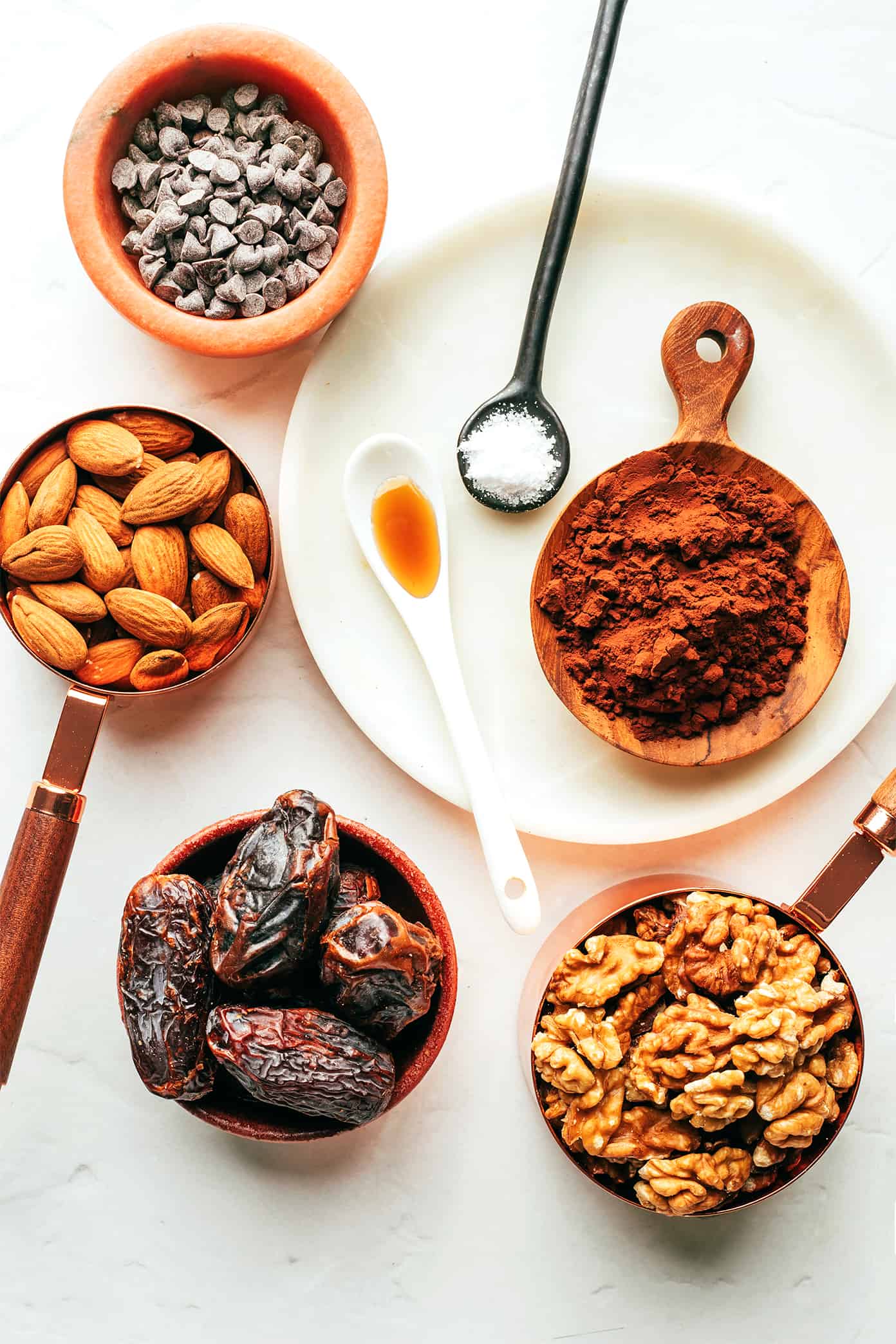 These salted chocolate brownie bites are quick and easy to make with nuts (almonds and walnuts), dates, cocoa powder, vanilla, sea salt and mini chocolate chips. A tasty breakfast, dessert, or snack made with healthier ingredients to satisfy those chocolate cravings! | gimmesomeoven.com Salted Chocolate Brownie Bites Ingredients